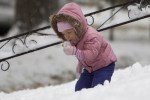 AUDREY CARSON, 3, PLAYS IN THE OCTOBER SNOW IN OMAHA / AP PHOTO