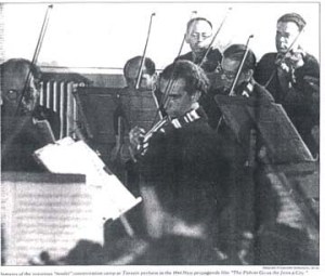 An orchestra of prisoners gives one of the concerts that on the one hand were encouraged by the Nazis and on the other hand helped the victims maintain their sanity.